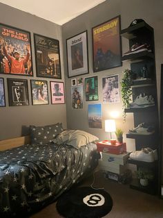 a bedroom with posters on the wall and a bed