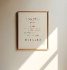 a framed poster hanging on the wall above a bed