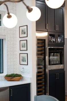 a kitchen with an oven, wine rack and cabinets in the corner next to it