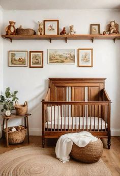 a baby's room with pictures on the wall