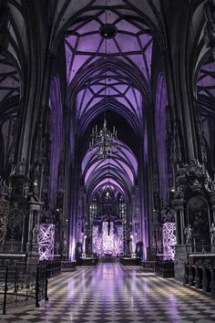 the inside of a large cathedral with purple lighting