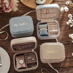 three personalized jewelry cases sitting on top of a wooden table