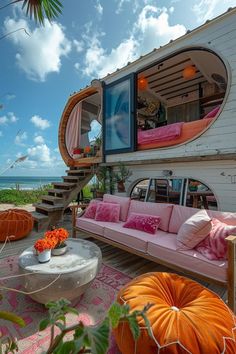 a living area with couches, tables and stairs leading up to the roof deck