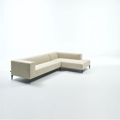 a white couch sitting on top of a white floor