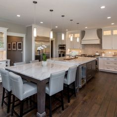 a large kitchen with an island in the middle