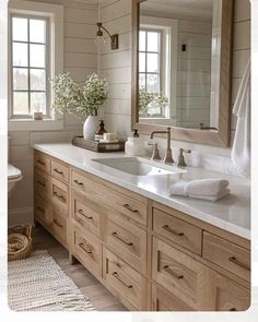 a bathroom with two sinks and mirrors in it