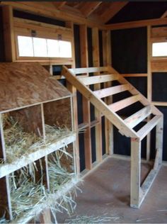 an unfinished house with hay bales and stairs