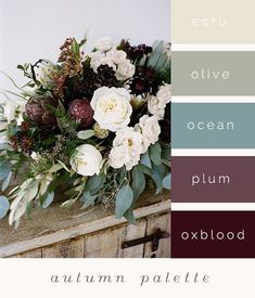 an arrangement of flowers and greenery in shades of red, white, green, and blue