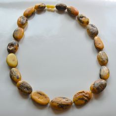 Baltic Amber Necklace Indulge in the timeless elegance of our Antique Colored Rustic Baltic Amber Necklace. This exquisite piece features larger-than-average beads full of Inclusions, each radiating a unique, old-world charm that is both captivating and sophisticated. 23 inches in length, largest focal bead measures 37X22X12mm. Made in Lithuania. You will receive one Necklace, the exact Necklace in the photos. Arrives to your home with the "All About Amber" Brochure which includes care instructions. Classic Necklace With Large Beads For Gift, Antique Amber Necklaces With Polished Beads, Antique Amber Round Bead Jewelry, Antique Amber Necklace With Polished Beads, Classic Amber Pendant Necklace, Antique Adjustable Necklaces With Round Beads, Elegant Amber Jewelry With Large Beads, Antique Adjustable Necklace With Round Beads, Oval Beaded Spiritual Necklaces