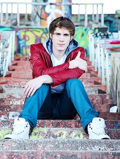 a young man is sitting on the stairs