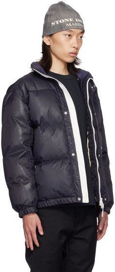 RDS-certified down-filled quilted nylon ripstop puffer jacket. Water-resistant and wind-resistant. · Stand collar · Two-way zip closure with press-stud placket · Logo printed at front and back · Welt pockets · Elasticized hem and cuffs · Adjustable press-stud fastening at side seams · Patch pocket at interior · Full taffeta lining · Logo-engraved silver-tone hardware Supplier color: Ink Supplier code: 8115446X1 Fill: 80% duck down, 20% duck feather. Nylon Puffer Jacket With Padded Collar For Cold Weather, Quilted Down Puffer Jacket For Streetwear, Streetwear Quilted Down Puffer Jacket, Functional Down Puffer Jacket With Padded Collar, Urban Puffer Jacket With Padded Collar And Duck Down, Weatherproof Nylon Puffer Jacket For Streetwear, Quilted Duck Down Streetwear Outerwear, Urban Weatherproof Down Puffer Jacket, Quilted Duck Down Outerwear For Streetwear