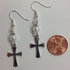 Delicate and simple cross charms dangle from pearlaccent beads. A great way to show your Christian faith. Earrings are sterling silver earwires (for happy ears). A great accessory! Silver Cross Jewelry With Pearl Drop, Faith Earrings, 1950s Earrings, Simple Cross, Pink Poodle, Dog Earrings, Life Symbol, Bird Charm, Cross Charms