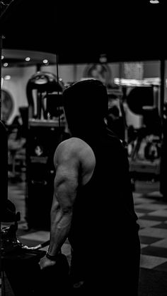 a man in the gym with his back to the camera