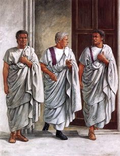 three men dressed in white robes standing next to each other with their hands on their hips