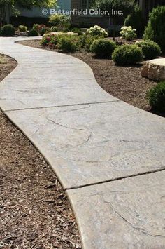 a stone walkway in front of a house