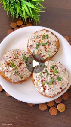 three pieces of bread on a plate with white frosting and sprinkles