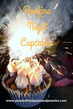 a cupcake with white frosting and sparklers