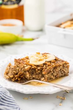 a white plate topped with granola and banana slices