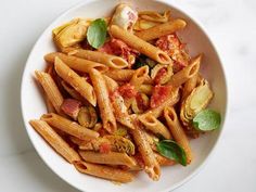 a white bowl filled with pasta and sauce