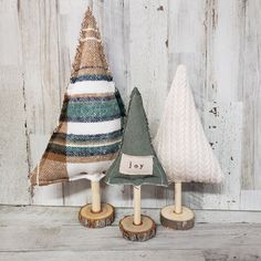 three small wooden christmas trees sitting next to each other