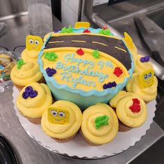 a birthday cake with yellow frosting and decorations