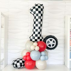 a car themed balloon sculpture in the shape of a checkered race car