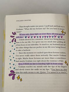 an open book with writing on the page and flowers in purple, yellow and blue