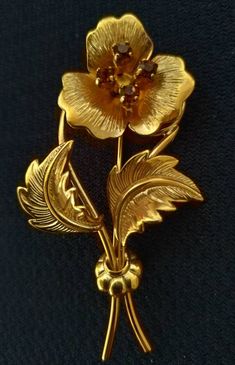 "Cute vintage gold plated brooch, with four orange precious stones Perfect condition Has the gold plate hallmarks Height 6 cm: 2 3/8\" I am happy to combine shipping" Victorian Gold Flower Brooches, Victorian Gold Flower Brooch, Antique Gold Flower Brooch, Antique Gold Flower Brooches, Gold Flower Brooch For Formal Occasions, Vintage Yellow Gold Flower Brooch, Vintage Yellow Gold Flower Brooches, Vintage Gold Flower Brooch, Vintage Gold Flower Brooches