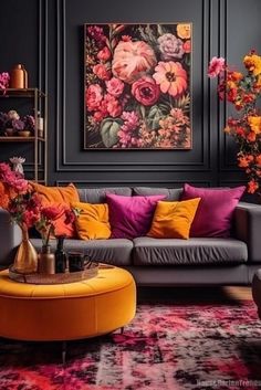 a living room filled with lots of furniture and colorful flowers on the wall behind it