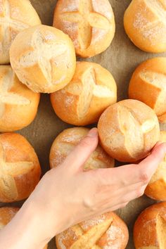 a person is reaching for some bread