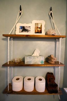 three shelves with toilet paper and pictures on them