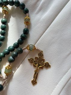 about this rosary ⬇️:  Hail Mary beads dyed wooden green beads  Our Father beads 8mm glass  beads.  Durable nylon cord  Gold tone crucifix  🌹 Say the Holy Rosary. Blessed be that monotony of Hail Mary's which purifies the monotony of your sins!"   -St. Josemaria Escriva With your rosary you'll receive a muslim reusable drawstring bag that can be used as a rosary pouch!  ⭐️ Because I use natural beads there may be a slight variations in their shape, size or colors.  ⭐️ To expand the life of your Handmade Green Spiritual Rosary Bracelet, Green Spiritual Rosary Bracelet With Round Beads, Green Beaded Spiritual Rosary, Spiritual Green Rosary Bracelet With Round Beads, Handmade Green Rosary, 8mm Bead Crucifix Rosary For Meditation, Green Rosary With 8mm Beads, Crucifix Rosary With 8mm Beads For Meditation, Green Rosary With Round Beads As Gift