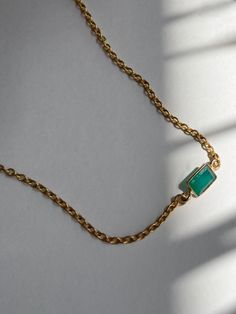 petite necklace with a mini rectangular green onyx stone charm. 
 ~ Encased green onyx stone ~ 18k gold-plated ringlet brass chain ~ 14-16" adjustable length ~ Lobster hook closure 
 ~ Each piece of jewelry comes in a velvet pouch in our signature box, perfect for gifting. Gift Yellow Gold Emerald Necklace With Adjustable Chain, Green Emerald Necklace With Adjustable Chain, Dainty Emerald Jewelry With Adjustable Chain, Dainty Gold Emerald Necklace With Adjustable Chain, Minimalist Green Emerald Necklace For Everyday, Gold Emerald Necklace With Adjustable Chain For May Birthstone, Everyday Minimalist Green Emerald Necklace, Minimalist Adjustable Emerald Jewelry, Green Delicate Chain Jewelry For Everyday