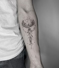 a man's arm with a tattoo on it that has an eagle and compass