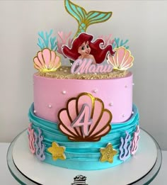 a birthday cake decorated with an ariel the mermaid theme