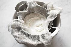 a white cloth wrapped around an electric blender on a marble counter top with the lid down