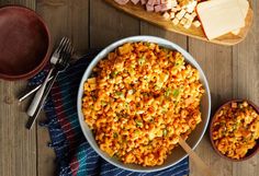 a bowl filled with macaroni and cheese on top of a wooden table