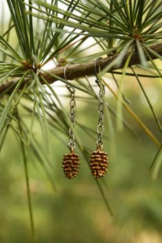 "Throughout the span of recorded human history, pinecones have served as a symbolic representation of human enlightenment, the third eye and the pineal gland. Conifer trees are one of the most ancient plant genera on the planet, having existed nearly three times longer than all flowering plant species. The Pinecone is the evolutionary precursor to the flower, and its spines spiral in a perfect Fibonacci sequence in either direction, much like the sacred geometry of a rose or a sunflower. Our \"p Yule Earrings, Pinecone Jewelry, Pinecone Earrings, Pine Cone Jewelry, Conifer Cone, Oak Leaf Earrings, Ladybug Jewelry, Pinecone Necklace, Fibonacci Sequence