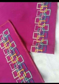 two pieces of pink fabric with colorful designs on them and one piece is made out of beads