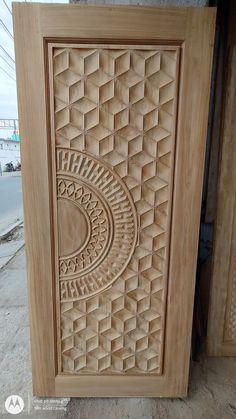 an intricately carved wooden door on the side of a building