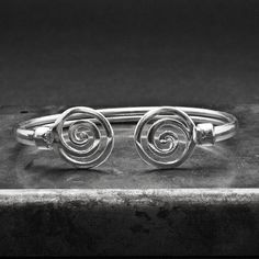 Unisex Spiral Cuff Sterling Silver Bracelet, Men/Women Greek Bracelet with Swirl, Men's Gift Bracelet, Greek Jewelry A handmade bracelet inspired by the ancient Greek spiral infinity symbol. A meaningful statement gift that is supposed to provide good luck and long life upon the wearer. Bangle bracelet width 5 mm approx. Made with soft 925 sterling silver so that may slightly expand/straightened Inner diameter 67 mm approx. Hallmarked 925 This is more of my Greek jewelry collection http://www.et Adjustable Spiral Silver Cuff Bracelet, Adjustable Silver Spiral Cuff Bracelet, Greek Bracelet, Gift Bracelet, Art Necklaces, Greek Jewelry, Bracelet Men, Art Pendant, Geometric Necklace