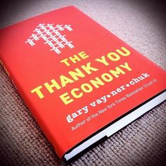 a red book with the words thank you economy written on it sitting on a carpet