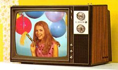 an old television with a girl holding balloons on it's face and the tv screen is turned off