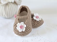 a pair of crocheted baby shoes sitting on top of a table