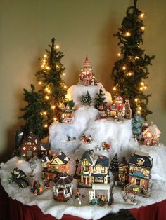 a table topped with snow covered houses and trees