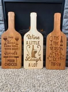 three wooden wine bottles sitting on top of a carpeted floor next to a fireplace