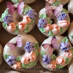 there are many doughnuts decorated with flowers and butterflies