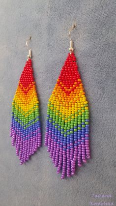 "These handmade author's earrings\" Rainbow flag LGBT \" are made of high-quality Czech beads and strong synthetic thread.In these unique earrings I use my author's scheme Rainbow flag LGBT . Color: red, orange, yellow, green, blue, purple. I will make these earrings for you in your color. Copy without my permission is prohibited 100% hand made with love! Measurements: Length with hook -10 cm( 3.93 inch ),Width -3 cm (1.18 inch) Materials: Silver plated ear hooks Czech glass beads Tytan Thread" Tie Dye Beaded Earrings, Beaded Rainbow Drop Earrings, Handmade Rainbow Beaded Dangle Earrings, Rainbow Dangle Beaded Earrings Handmade, Rainbow Handmade Beaded Dangle Earrings, Rainbow Dangle Earrings With Tiny Beads, Rainbow Round Bead Earrings For Gifts, Rainbow Round Beads Earrings For Gift, Rainbow Beaded Drop Earrings