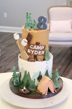 a birthday cake with camping themed decorations on it