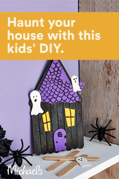 a halloween card with a house made out of popsicle sticks and fake ghost legs